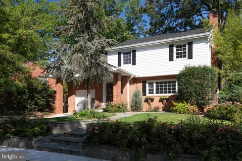 a front view of house with a garden