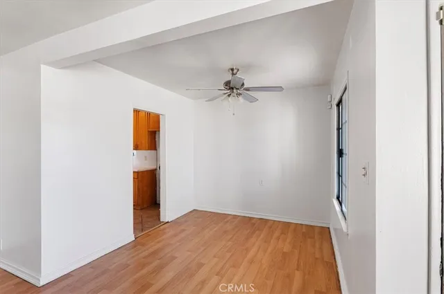 a kitchen with cabinets a sink and a stove with wooden floor