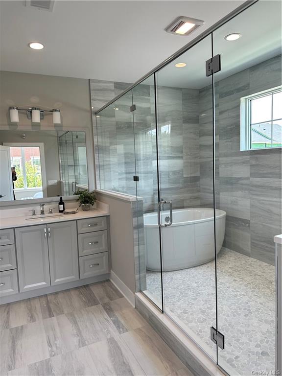 a bathroom with a shower sink and mirror