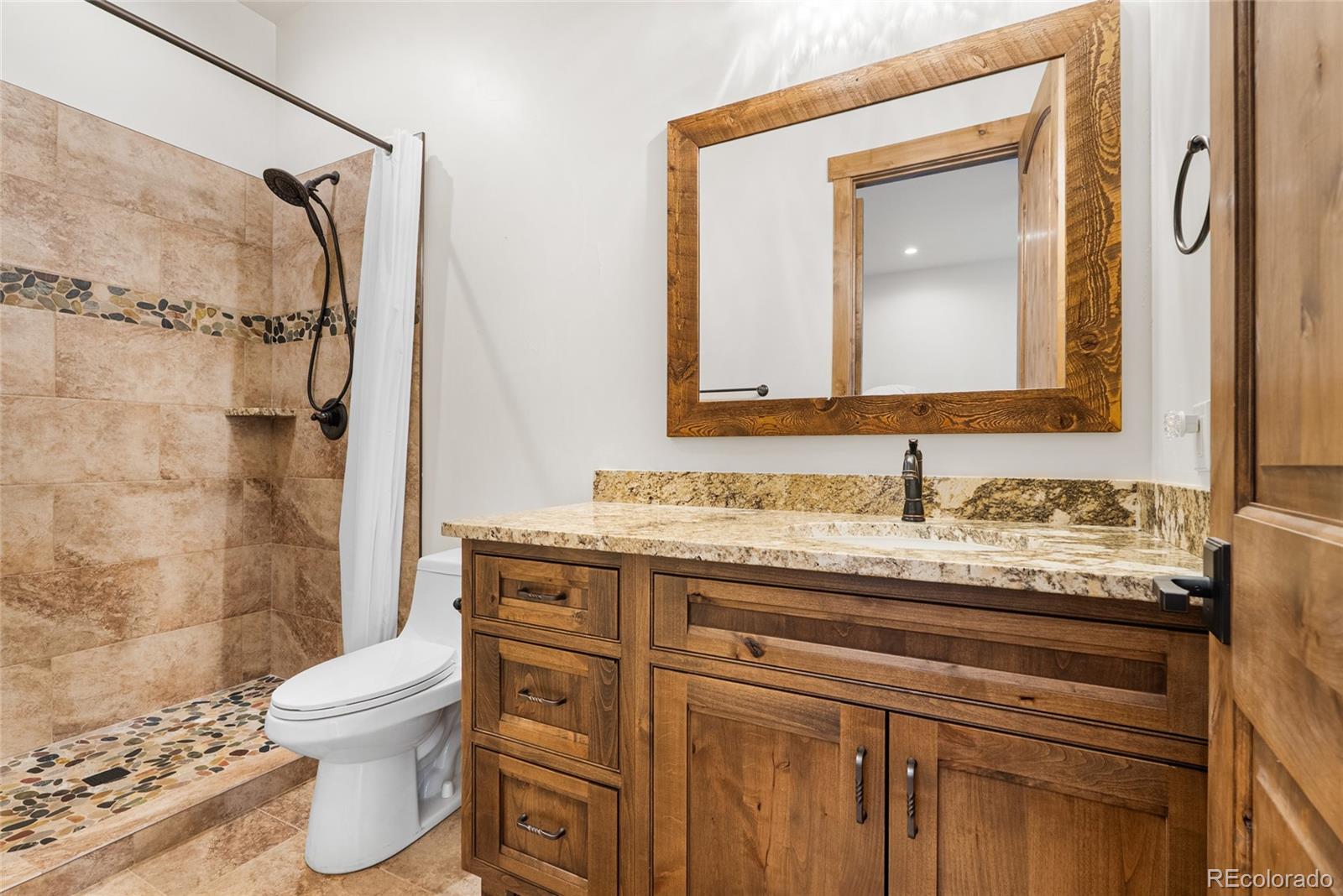 280 Double Tree Road Bailey, CO 80421 - Photo 23 of 43 a bathroom with a granite countertop sink toilet and shower