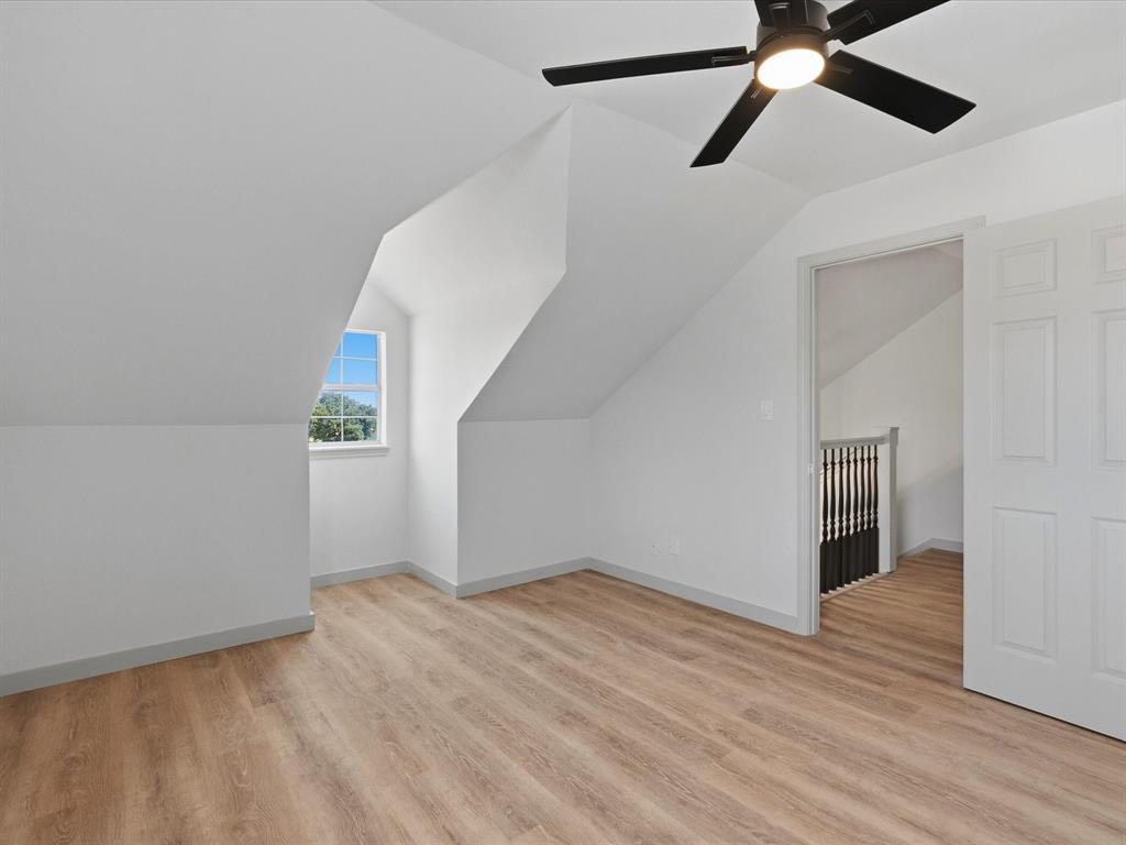 289 County Road 4655 Rhome, TX 76078 - Photo 18 of 34 Upstairs Bedroom featuring wood-finish flooring, a contemporary ceiling fan with integrated lighting