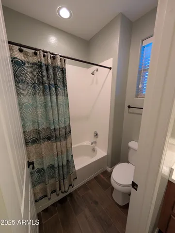 a bathroom with a toilet and a shower
