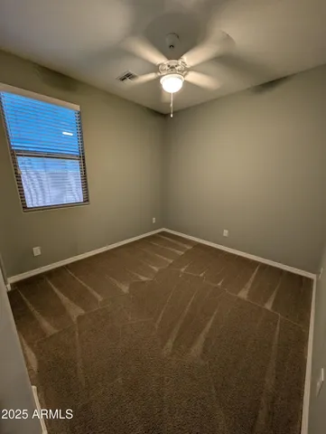 en empty room with a fan