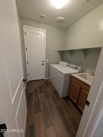 a storage & utility room with a sink
