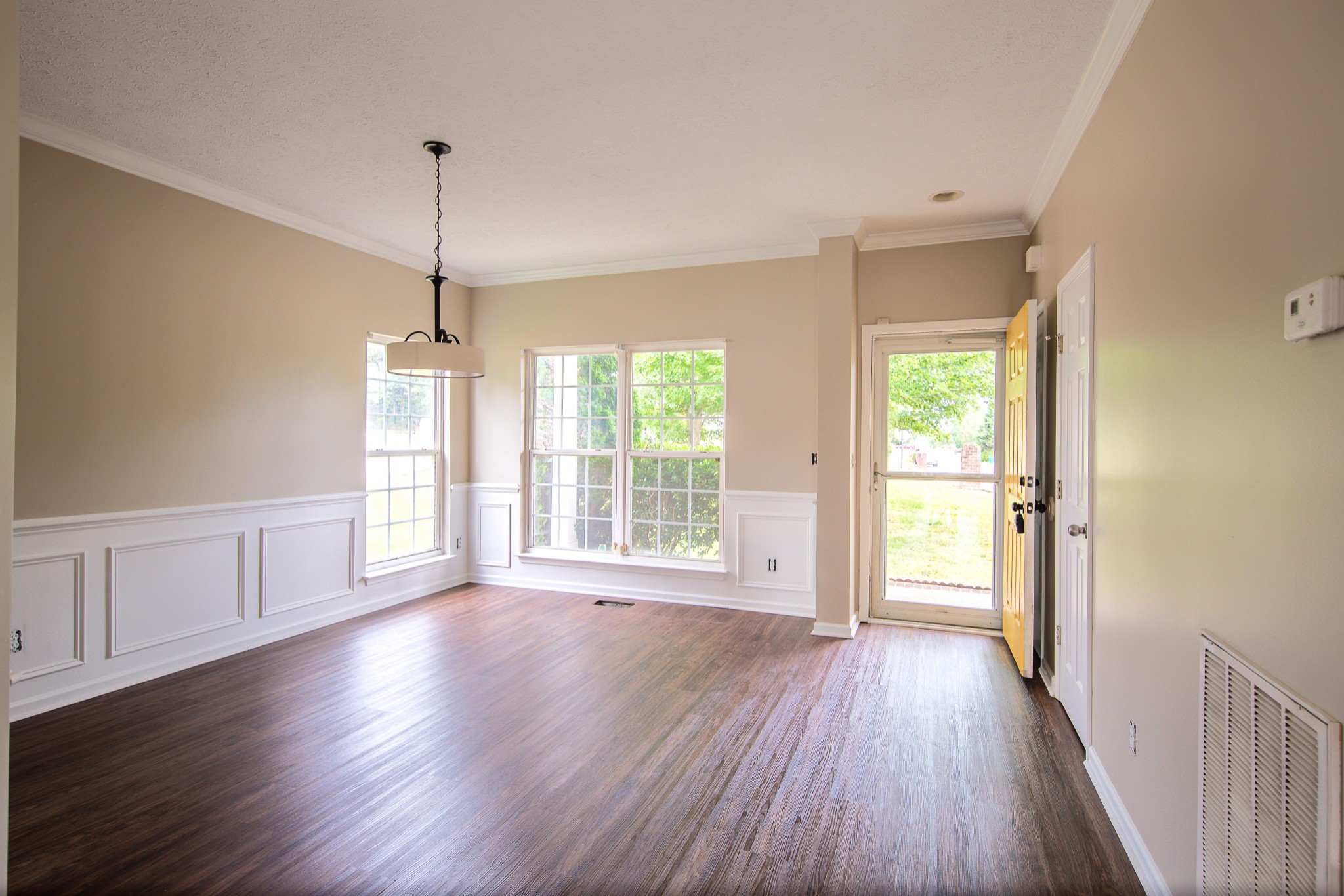 1910 Portway Road Spring Hill, TN 37174 - Photo 2 of 20 a view of an empty room with wooden floor and a window