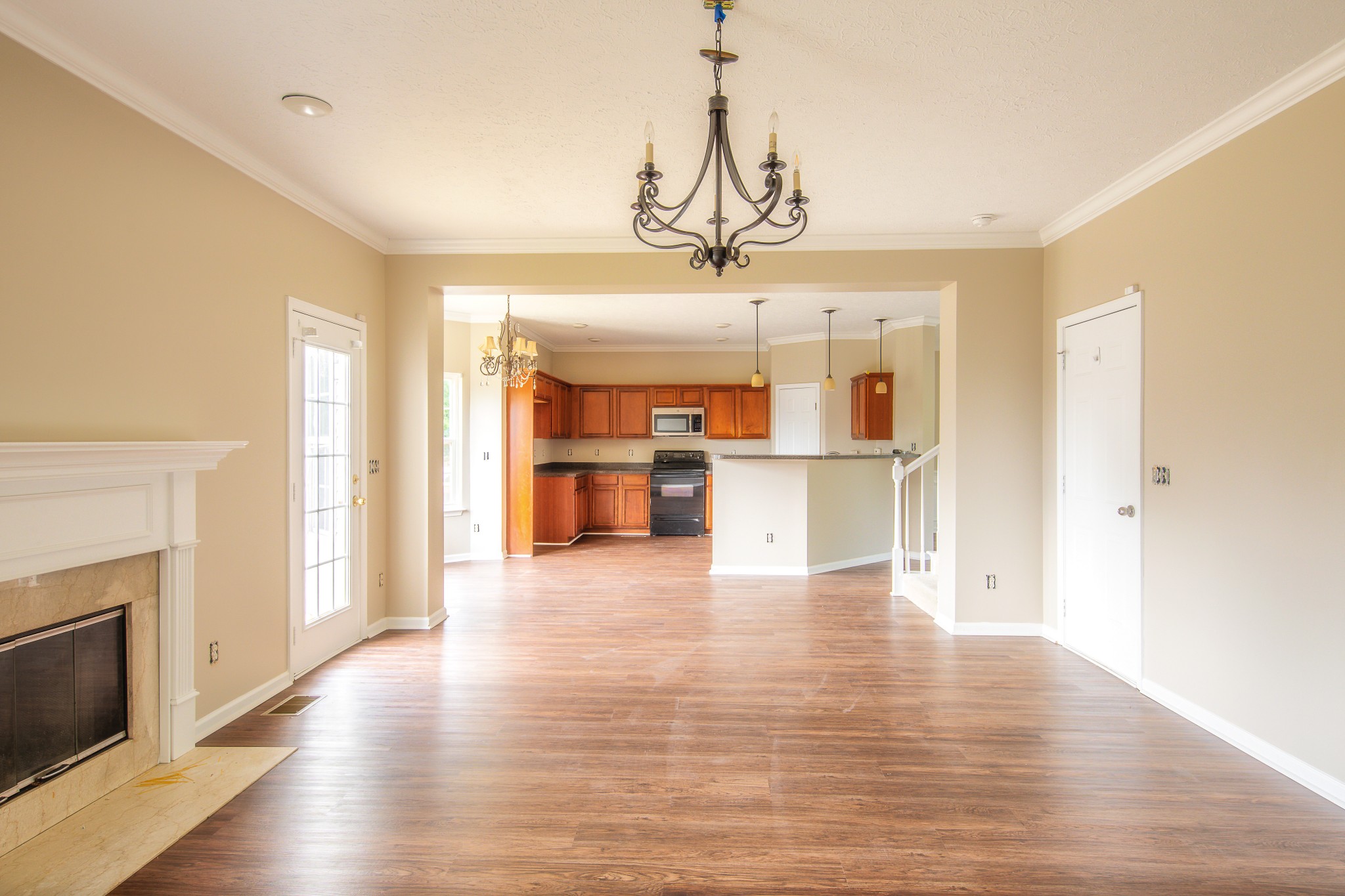 1910 Portway Road Spring Hill, TN 37174 - Photo 7 of 20 a view of a hallway with wooden floor and a kitchen