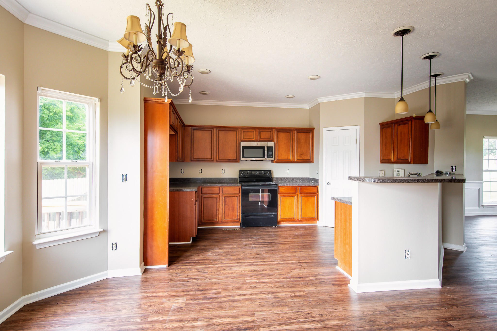 1910 Portway Road Spring Hill, TN 37174 - Photo 9 of 20 a kitchen with stainless steel appliances granite countertop a refrigerator a sink dishwasher a stove and a dining table with wooden floor