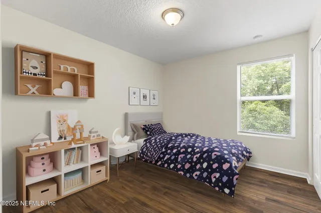 a bedroom with furniture and a wooden floor