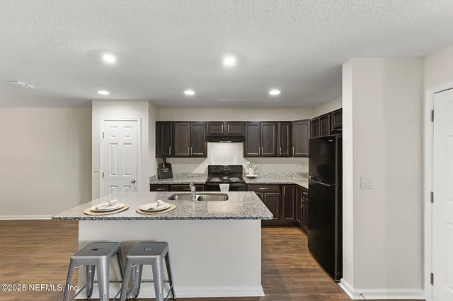 a kitchen with stainless steel appliances granite countertop a stove and a refrigerator