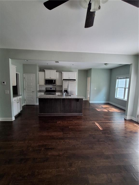 110 Spetchley Way Bogart, GA 30622 - Photo 4 of 13 a view of kitchen and hall with wooden floor