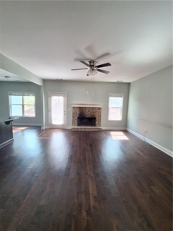 110 Spetchley Way Bogart, GA 30622 - Photo 5 of 13 an empty room with wooden floor fireplace and windows
