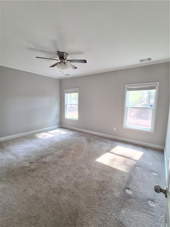 110 Spetchley Way Bogart, GA 30622 - Photo 8 of 13 an empty room with windows and chandelier fan