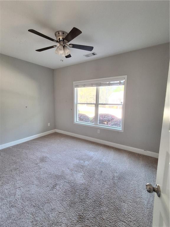 110 Spetchley Way Bogart, GA 30622 - Photo 9 of 13 an empty room with windows and fan