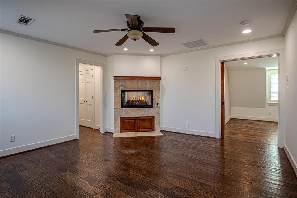 9310 Merritt Road Rowlett, TX 75089 - Photo 12 of 40 a view of a livingroom with wooden floor a ceiling fan and a ceiling fan