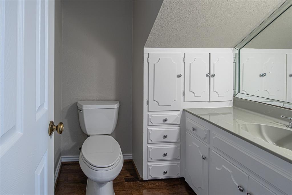 9310 Merritt Road Rowlett, TX 75089 - Photo 26 of 40 a bathroom with a granite countertop toilet and sink