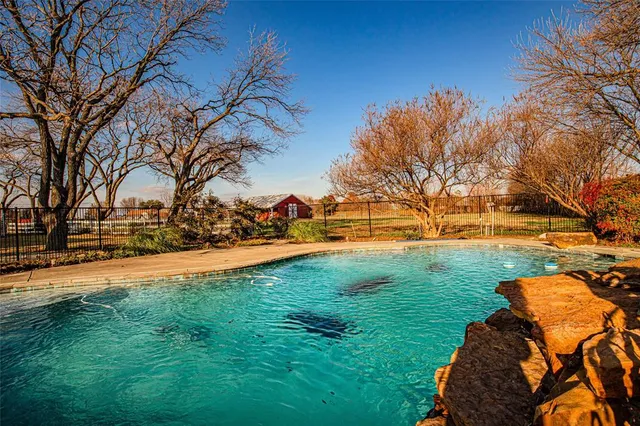 a view of yard with swimming pool and green space