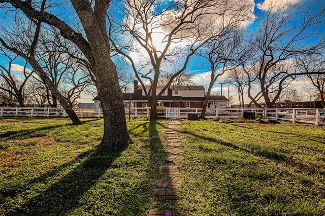 a view of yard with swimming pool and trees