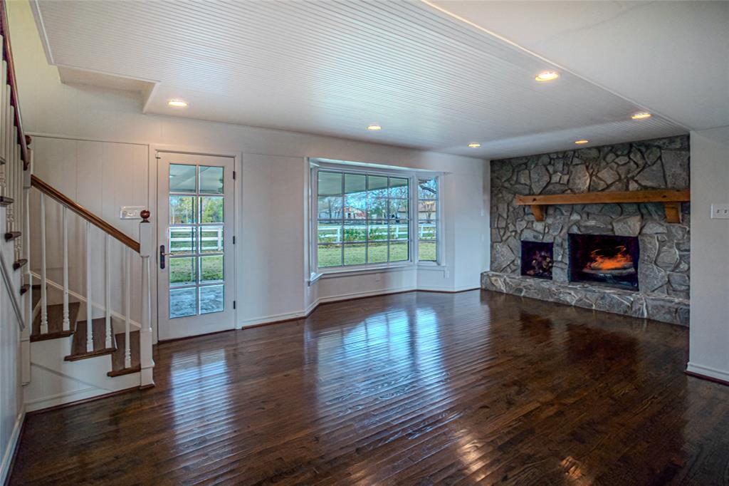 9310 Merritt Road Rowlett, TX 75089 - Photo 8 of 40 a living room with wooden floor and a fireplace