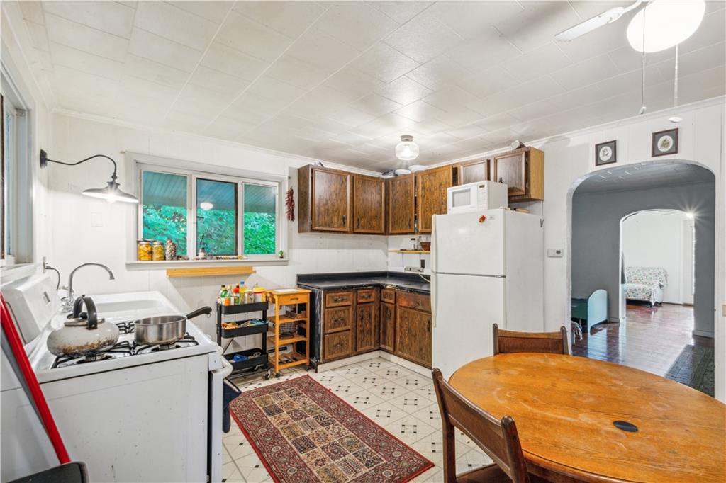 728 State Rte 1033 Templeton, PA 16259 - Photo 22 of 49 a kitchen with granite countertop a sink stove and refrigerator