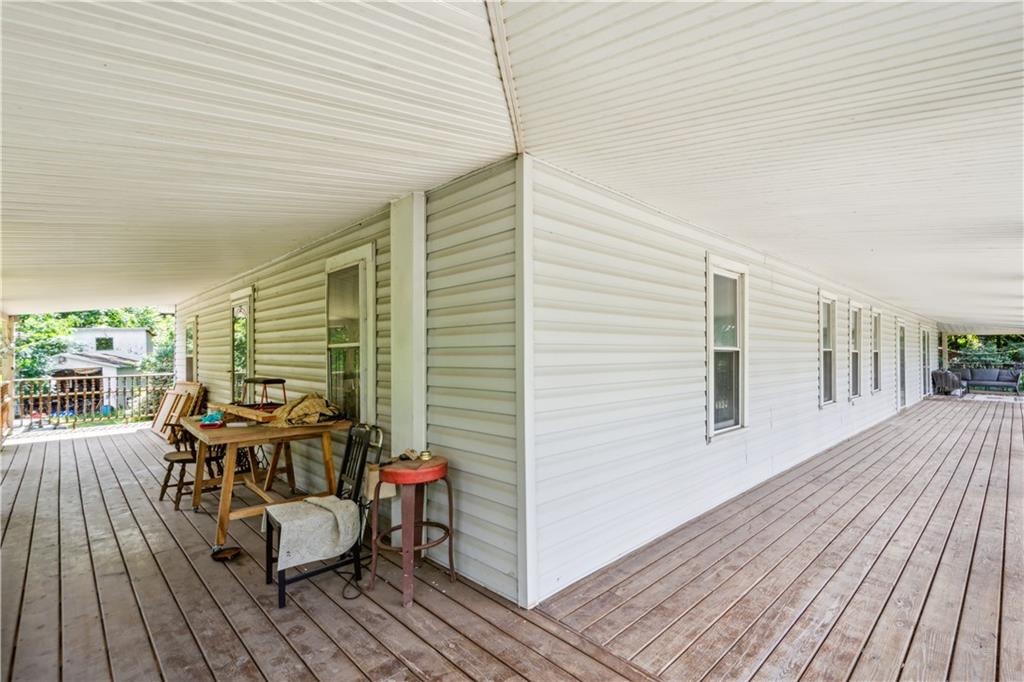 728 State Rte 1033 Templeton, PA 16259 - Photo 31 of 49 a view of a roof deck with table and chairs wooden floor and fence