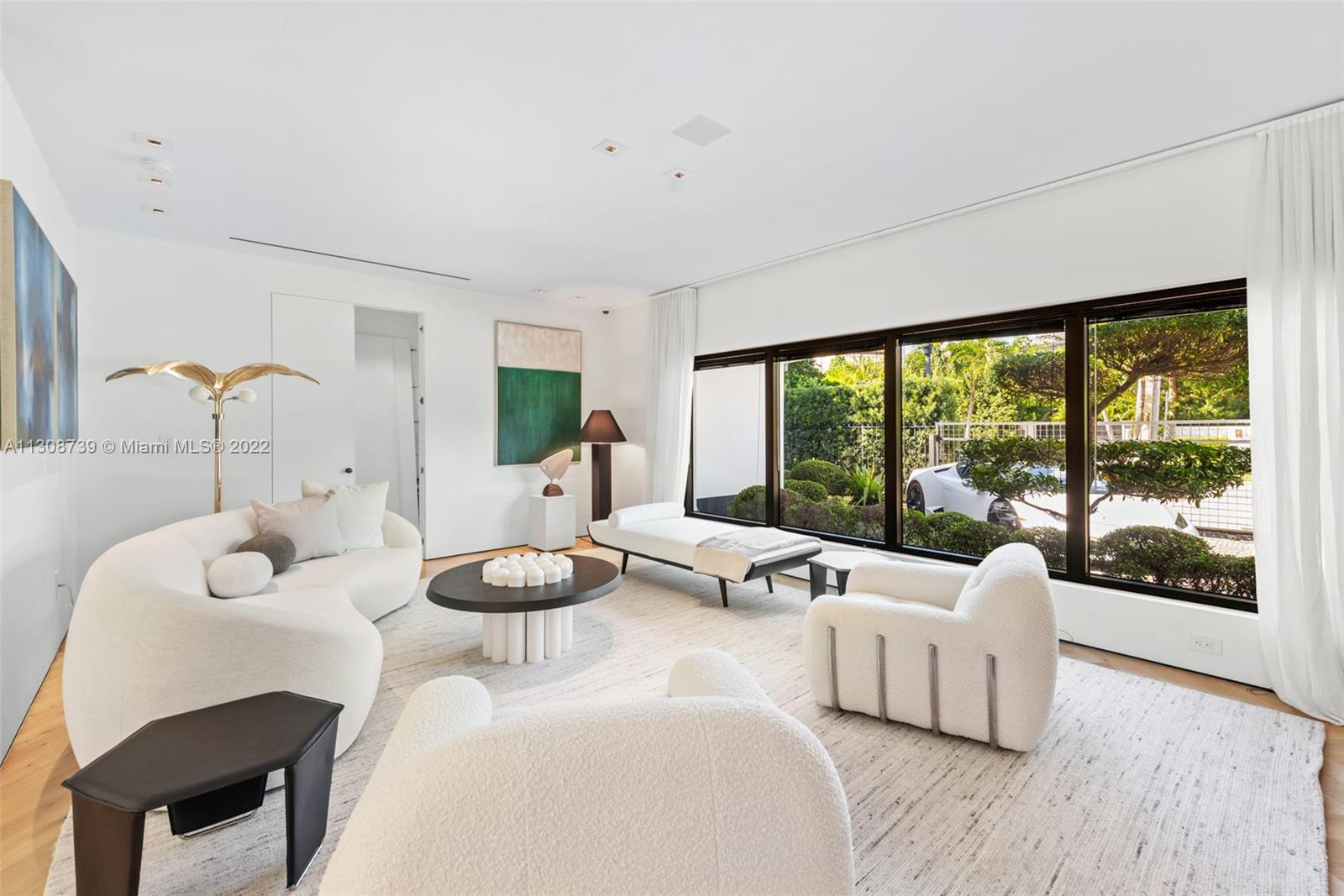 2021 North Bay Road Miami Beach, FL 33140 - Photo 11 of 38 a living room with furniture and a large window