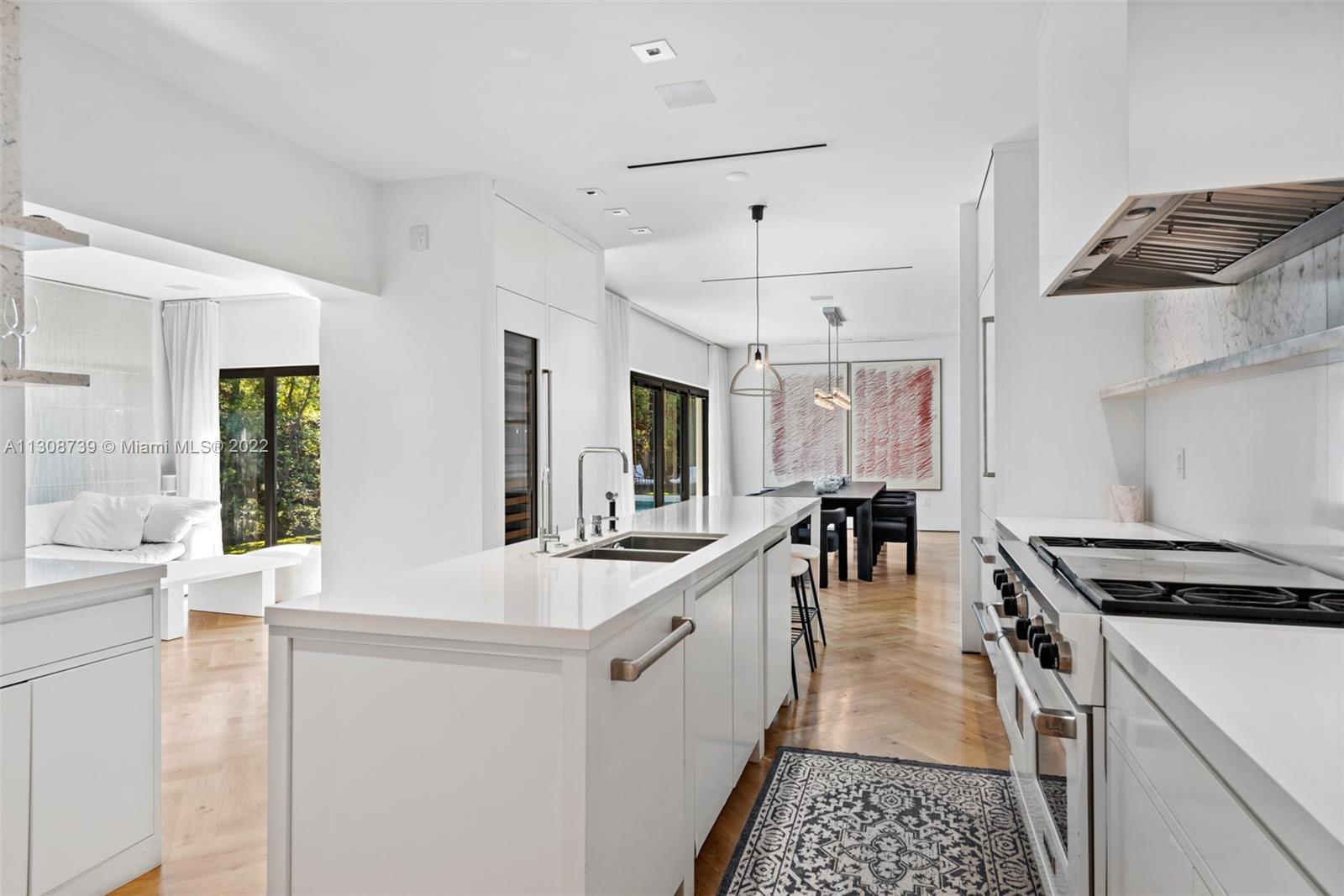 2021 North Bay Road Miami Beach, FL 33140 - Photo 14 of 38 a kitchen with stainless steel appliances a stove a sink and a refrigerator