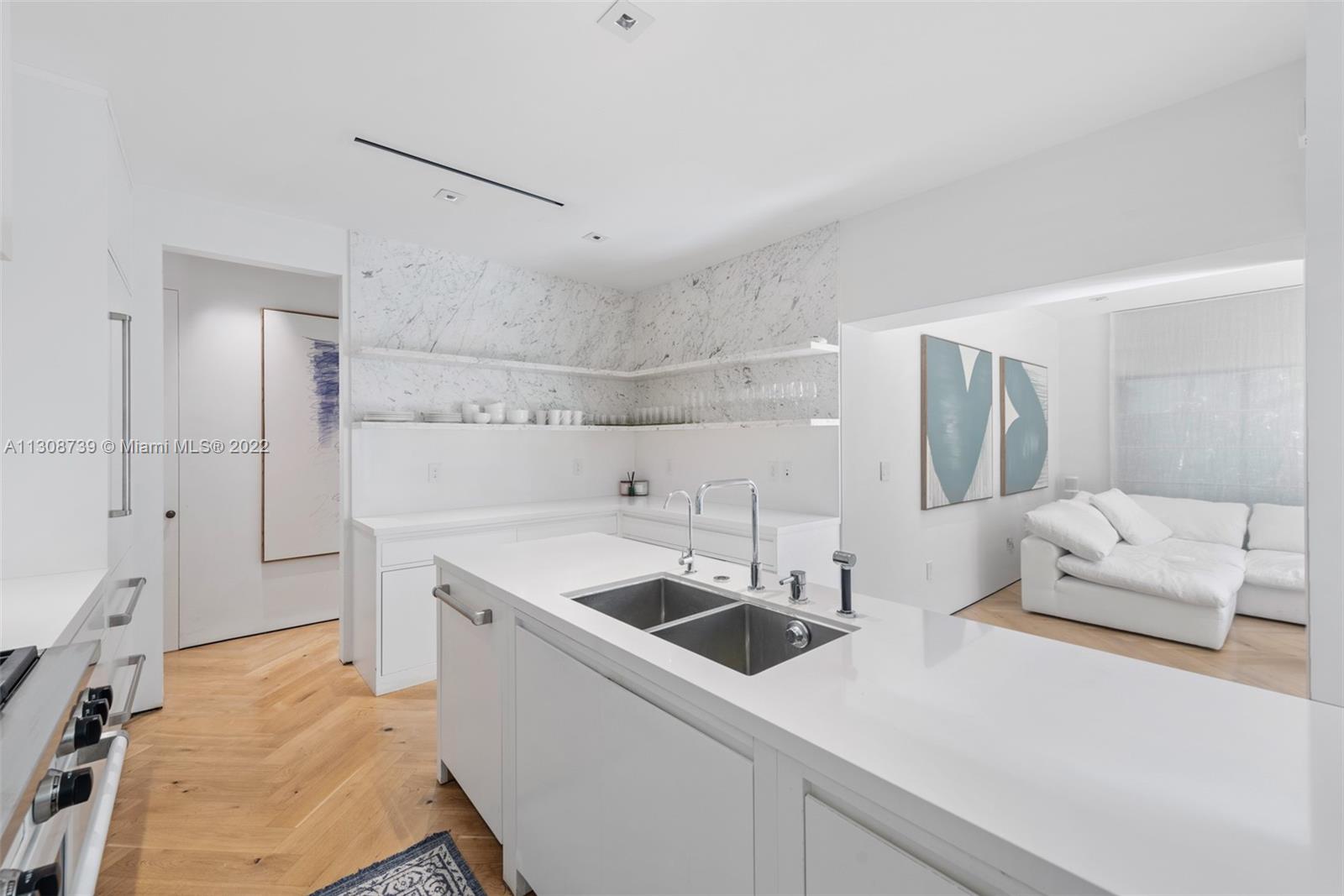 2021 North Bay Road Miami Beach, FL 33140 - Photo 17 of 38 a utility room with cabinets washer and dryer