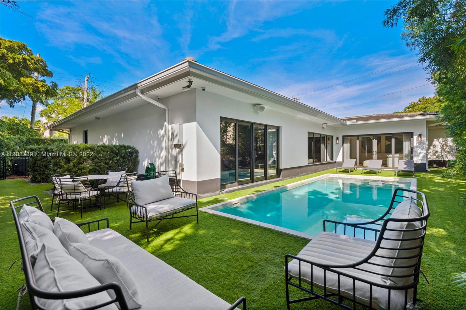 2021 North Bay Road Miami Beach, FL 33140 - Photo 2 of 38 a view of a house with a yard patio and swimming pool