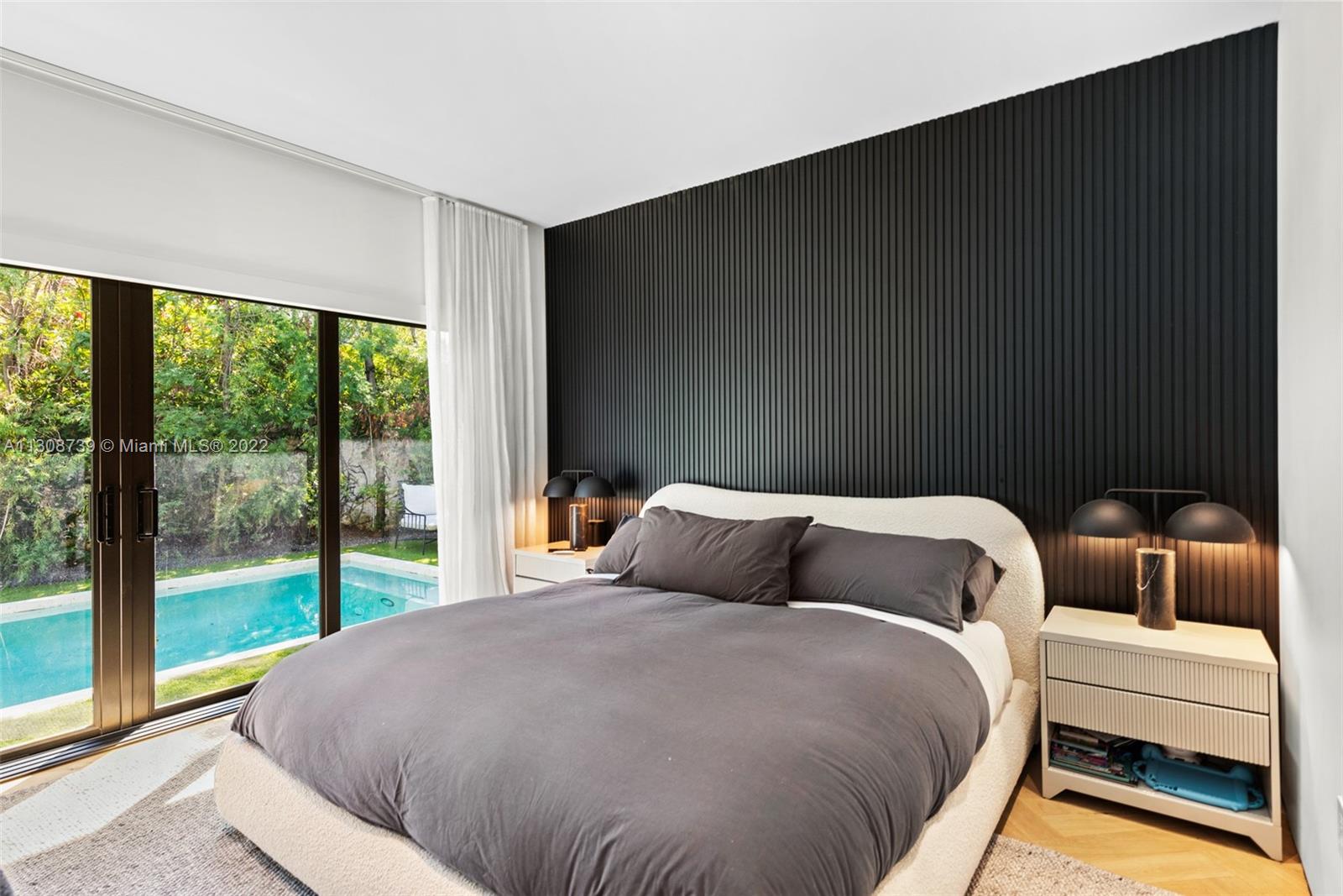 2021 North Bay Road Miami Beach, FL 33140 - Photo 22 of 38 a bedroom with a bed and glass window