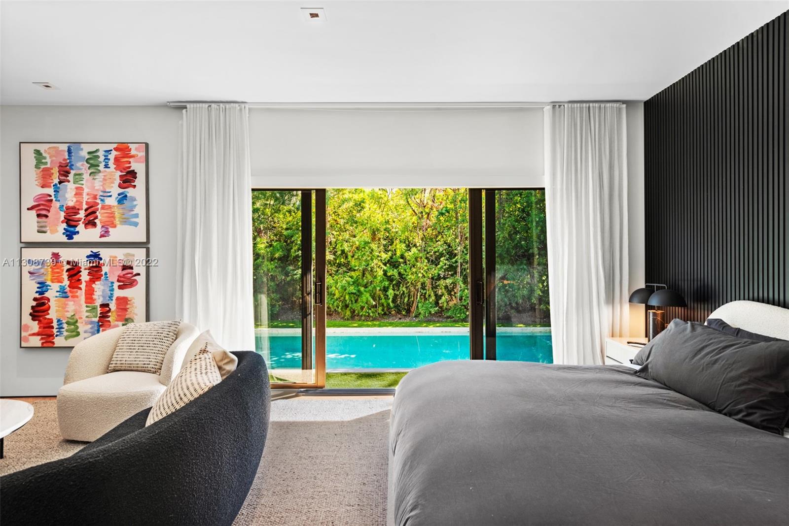 2021 North Bay Road Miami Beach, FL 33140 - Photo 24 of 38 a bedroom with furniture and a large window