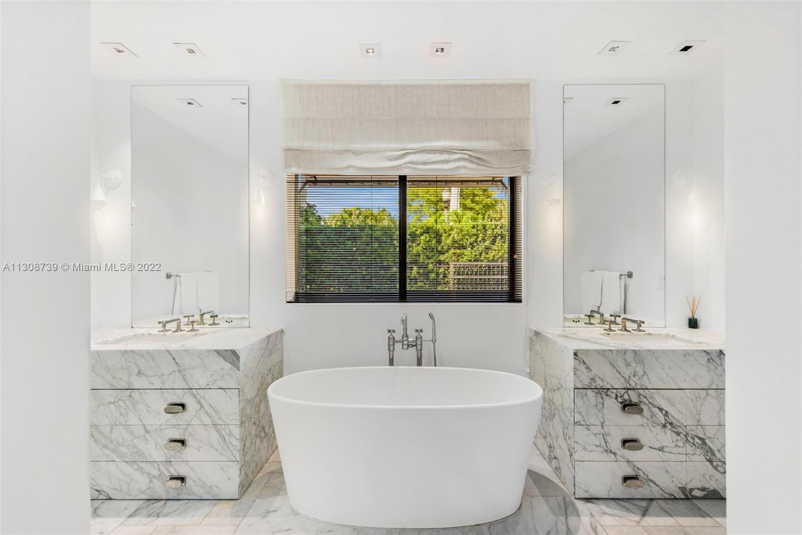 2021 North Bay Road Miami Beach, FL 33140 - Photo 26 of 38 a white bath tub sitting in a bathroom