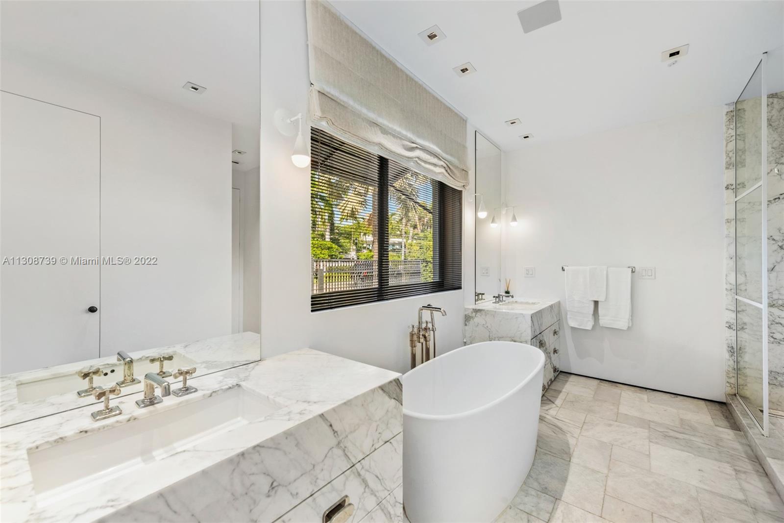 2021 North Bay Road Miami Beach, FL 33140 - Photo 27 of 38 a bathroom with a sink and a mirror