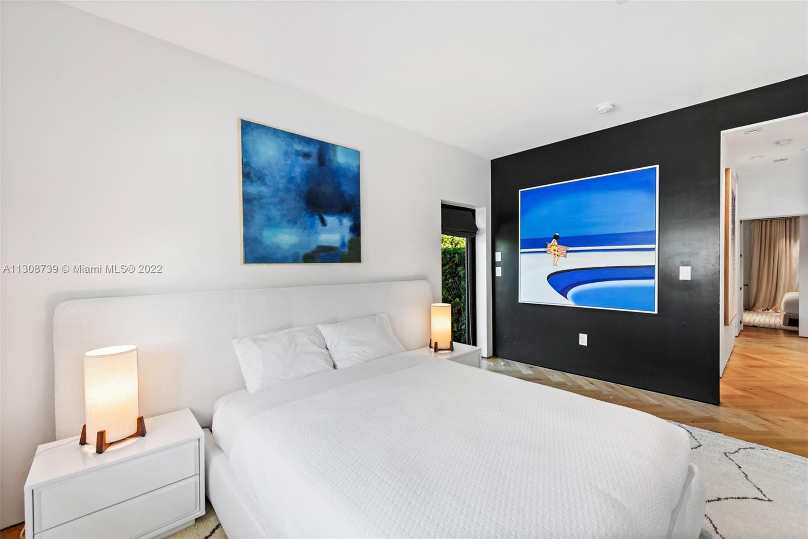 2021 North Bay Road Miami Beach, FL 33140 - Photo 33 of 38 a bedroom with a bed and a lamp on dresser