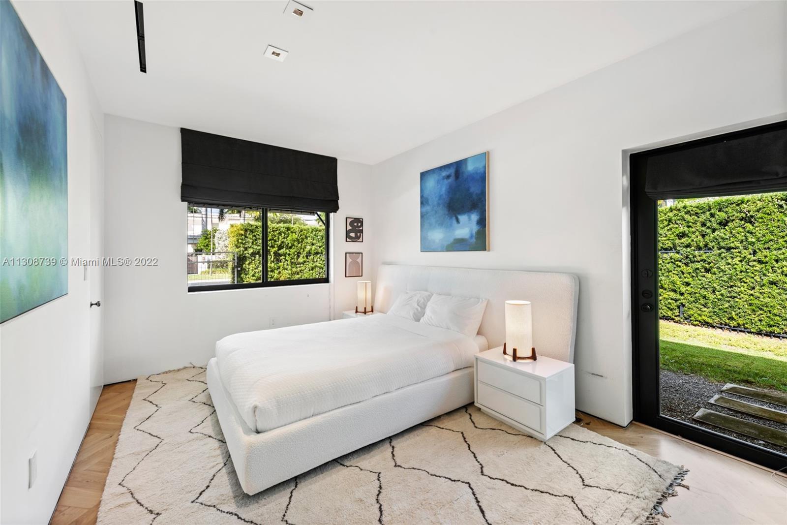 2021 North Bay Road Miami Beach, FL 33140 - Photo 34 of 38 a bedroom with a large bed and a window