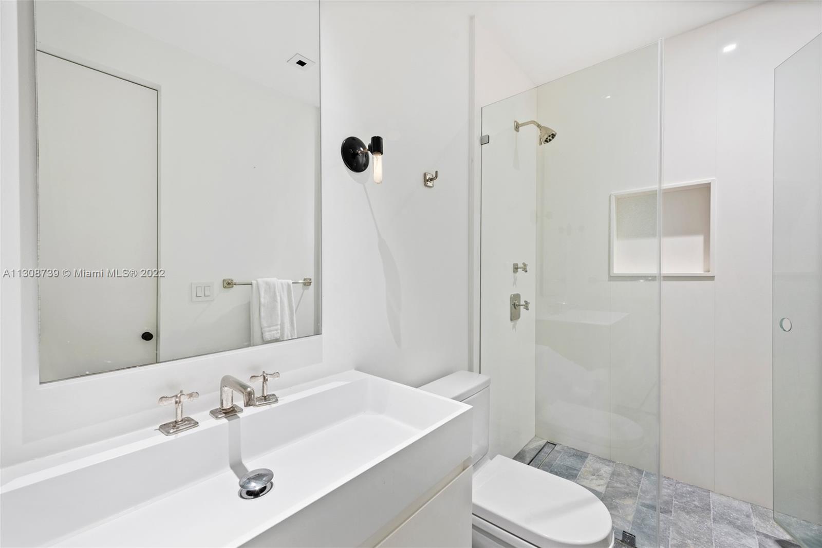 2021 North Bay Road Miami Beach, FL 33140 - Photo 35 of 38 a bathroom with a sink toilet a mirror and shower