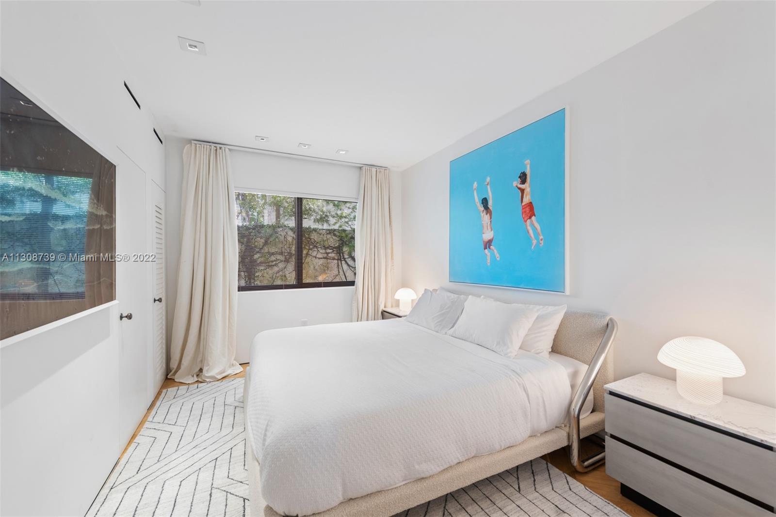 2021 North Bay Road Miami Beach, FL 33140 - Photo 36 of 38 a bedroom with a bed and a painting on the wall