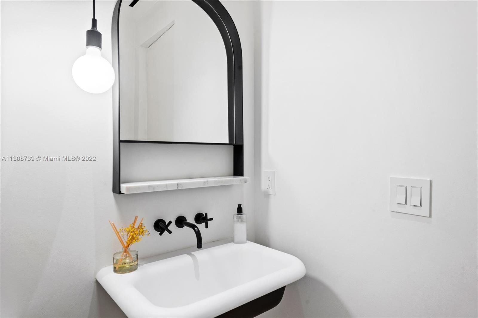 2021 North Bay Road Miami Beach, FL 33140 - Photo 38 of 38 a bathroom with a sink and a mirror