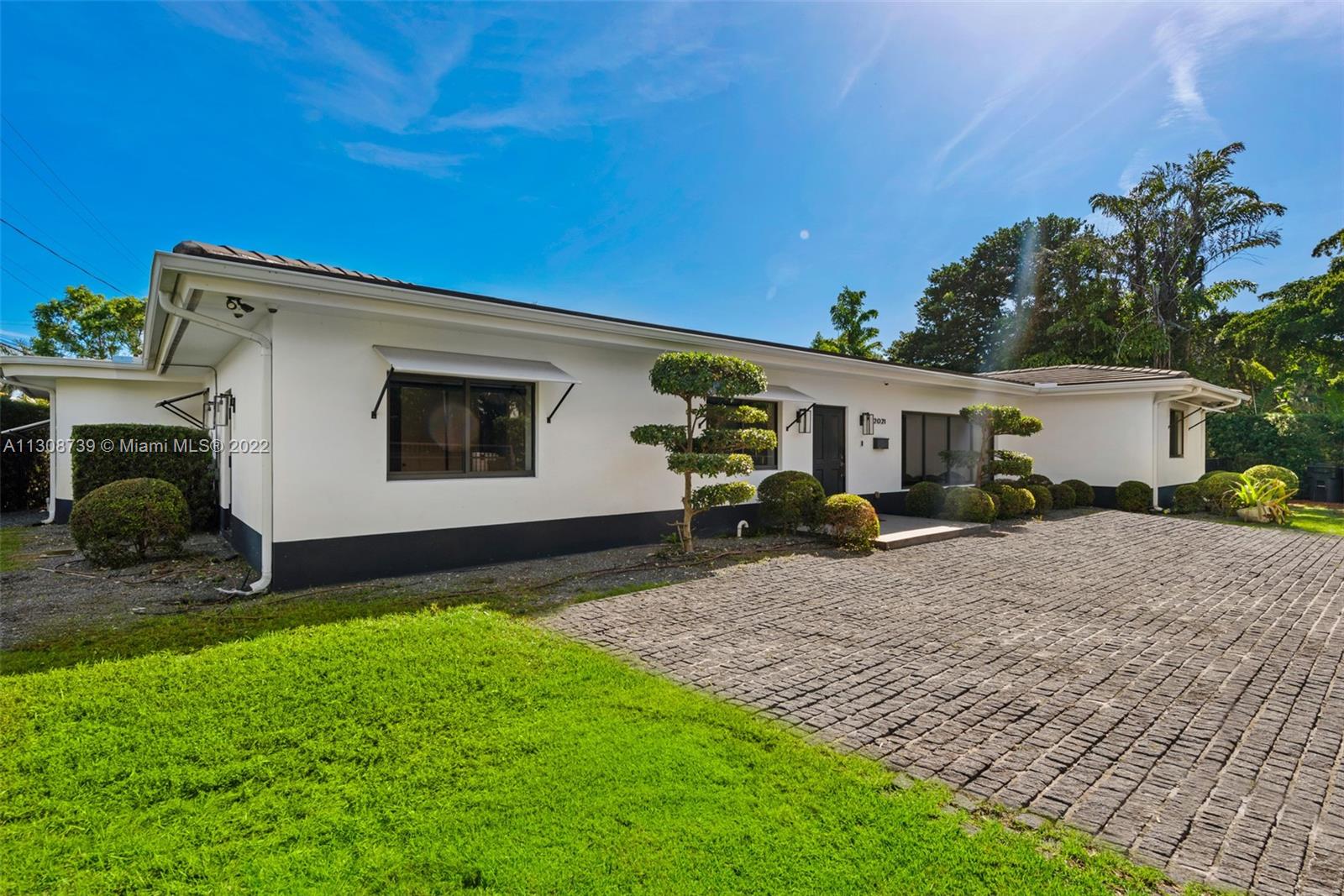 2021 North Bay Road Miami Beach, FL 33140 - Photo 7 of 38 a front view of a house with garden