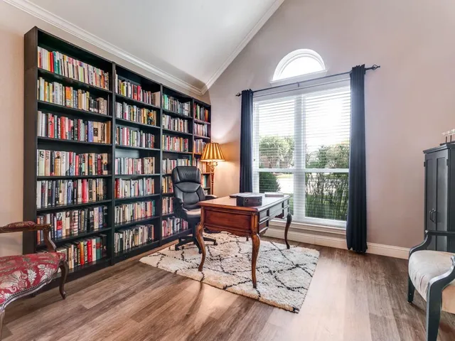 a living room with furniture and a book shelf