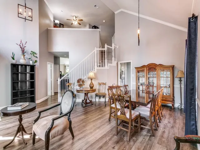 a view of a dining room with furniture and wooden floor