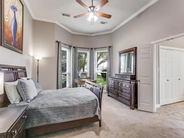 a bedroom with a bed and ceiling fan