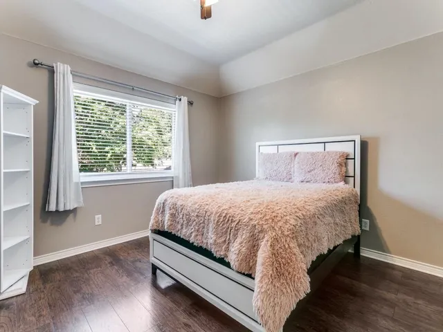 a bed sitting in a bedroom next to a window