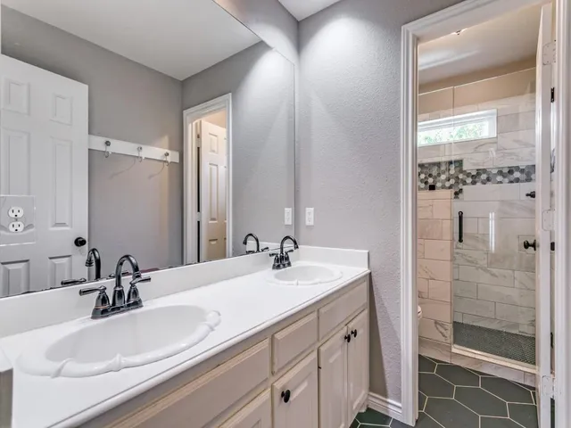 a bathroom with a double vanity sink mirror and double