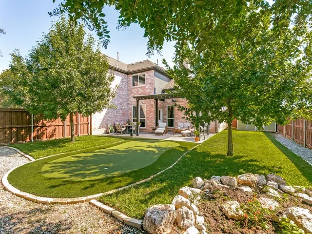 a swimming pool with outdoor seating and yard