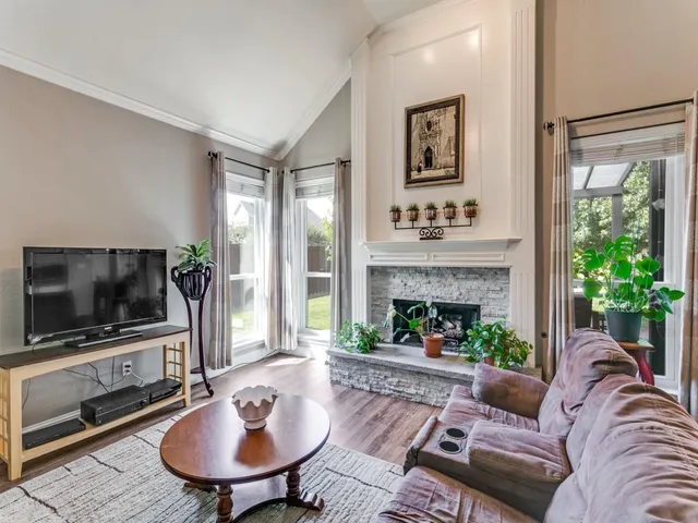 a living room with furniture a fireplace and a flat screen tv
