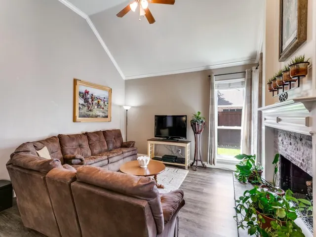 a living room with furniture a fireplace and a flat screen tv