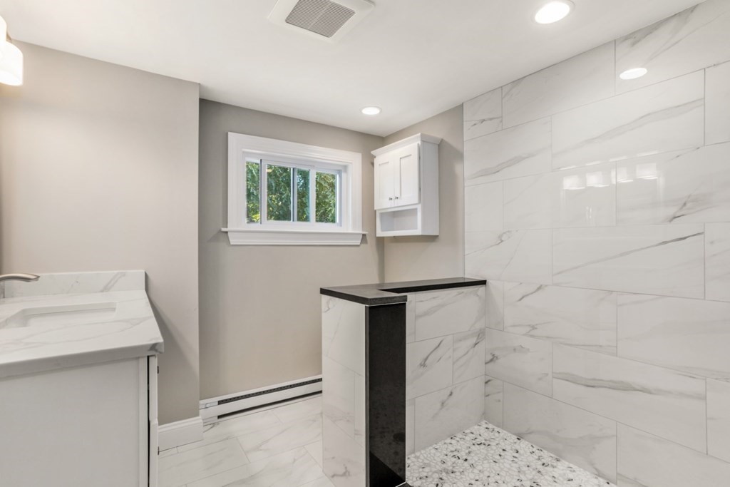11 Allison Road Saugus, MA 01906 - Photo 21 of 28 a bathroom with a sink and a mirror