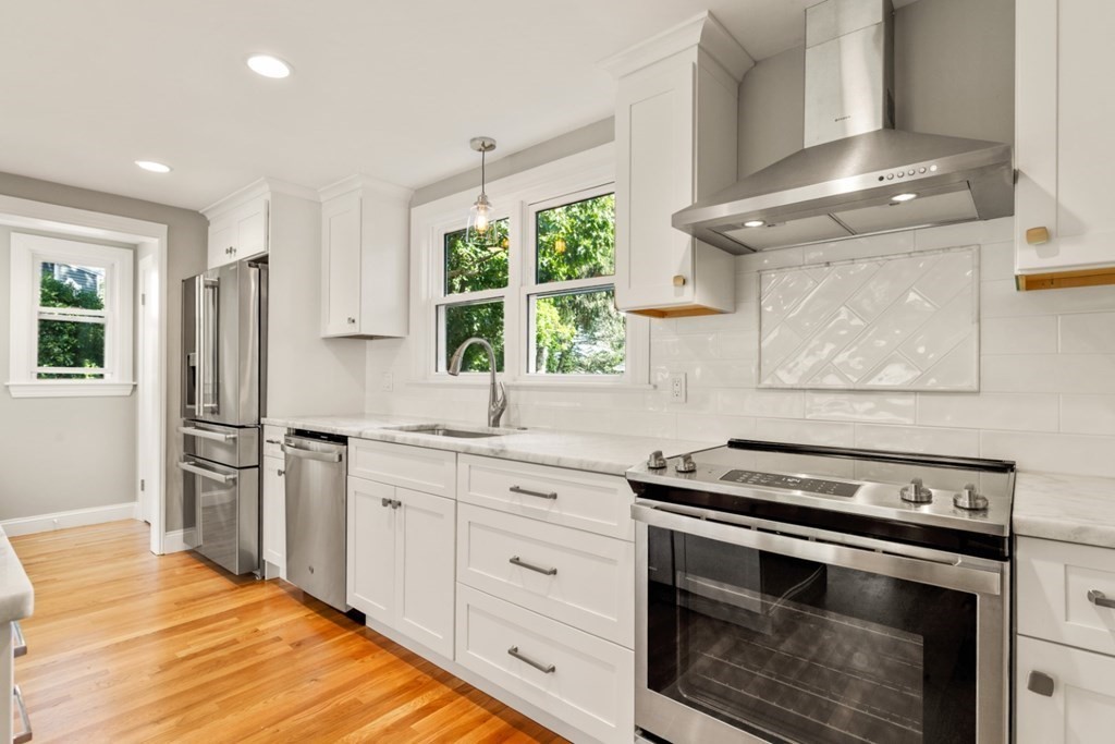 11 Allison Road Saugus, MA 01906 - Photo 3 of 28 a kitchen with stainless steel appliances a stove a sink and a refrigerator