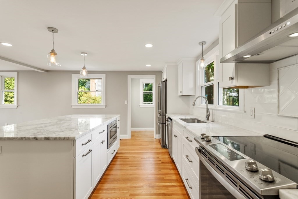 11 Allison Road Saugus, MA 01906 - Photo 4 of 28 a large kitchen with stainless steel appliances granite countertop a lot of counter space