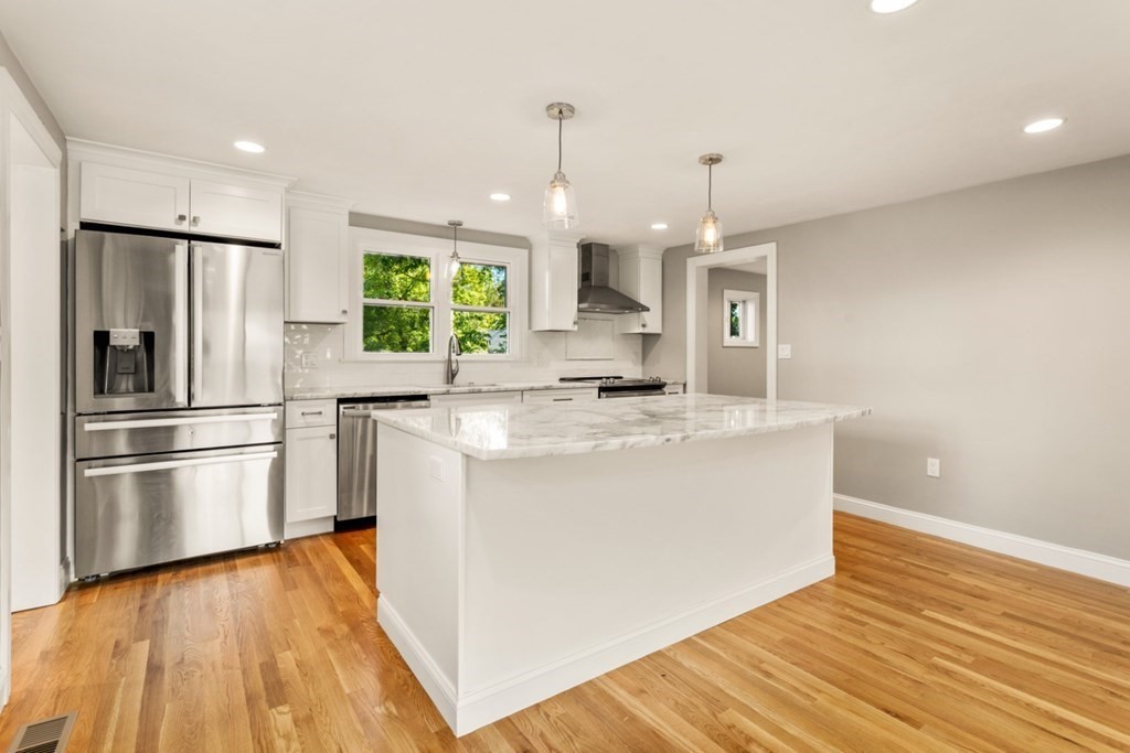 11 Allison Road Saugus, MA 01906 - Photo 6 of 28 a kitchen with stainless steel appliances granite countertop a refrigerator a stove a sink dishwasher and a refrigerator with wooden floor
